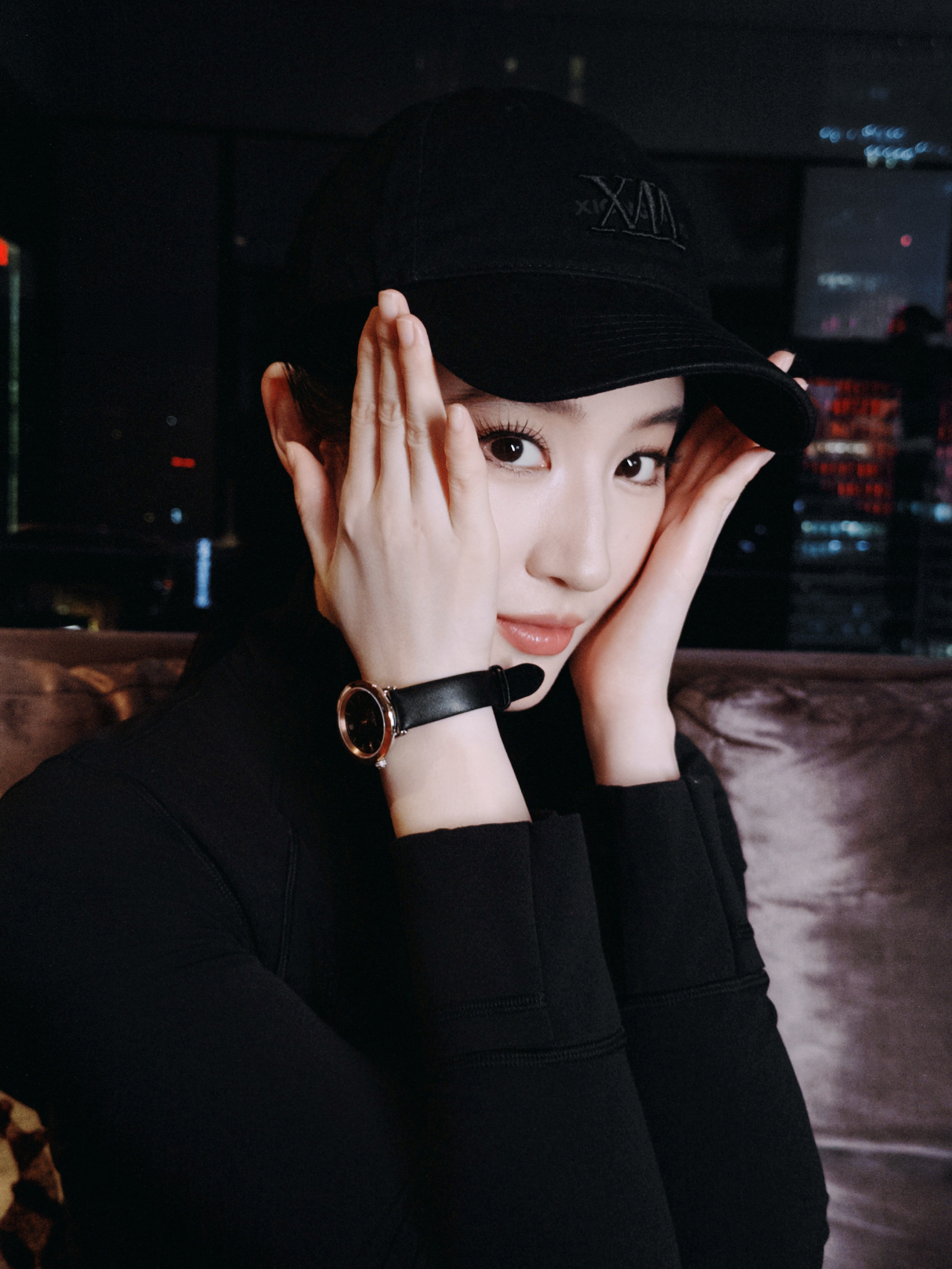 夜色漫过城市的窗，窗外万家灯火明明灭灭，照片里的她一身黑衣，戴着既酷又萌的帽子，