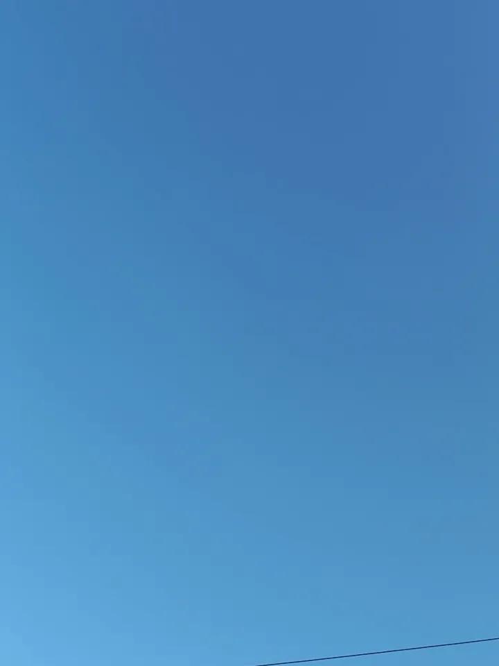 天空是蓝色的，像一块巨大的蓝宝石，纯净又深邃。站在这蓝天下，低头便能看到地下的花