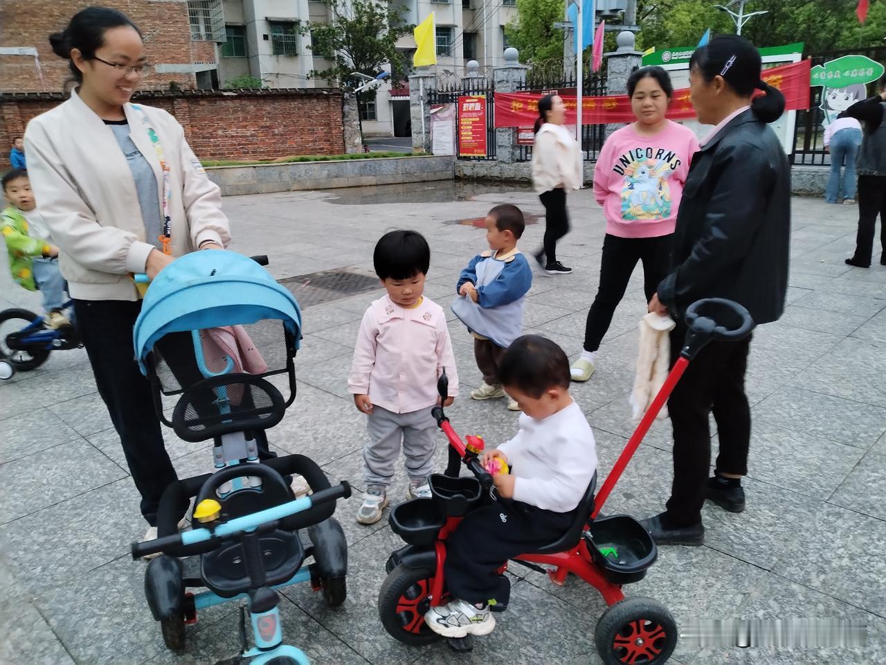 傍晚，我带着孙女到学校大门前的坪上玩耍。两三岁的小朋友们总爱聚在一块儿，总有些让