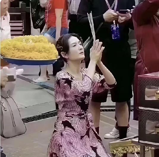 曼谷，四面佛跟前。
谢娜跪下去，香举过头顶，额头贴地。
四面佛在曼谷闹市区，香火