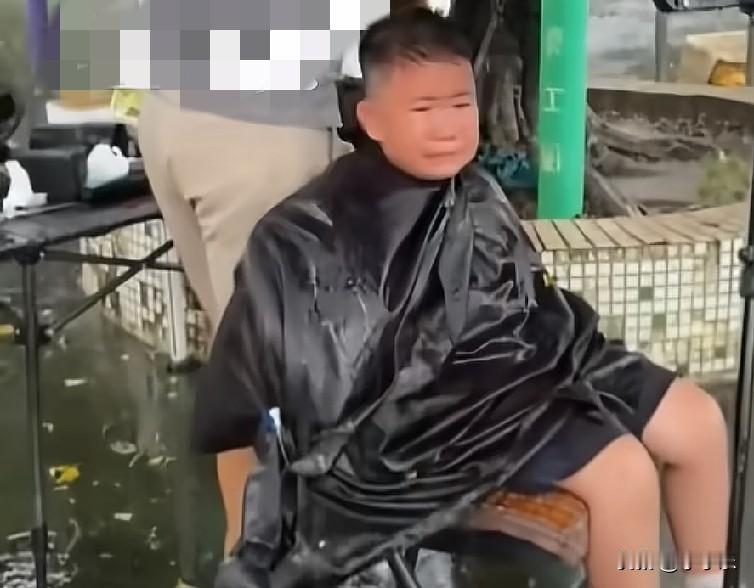 近日，广东一妈妈带儿子到户外流动理发摊剪头发，中途突然狂风四起，大雨倾盆而下，可
