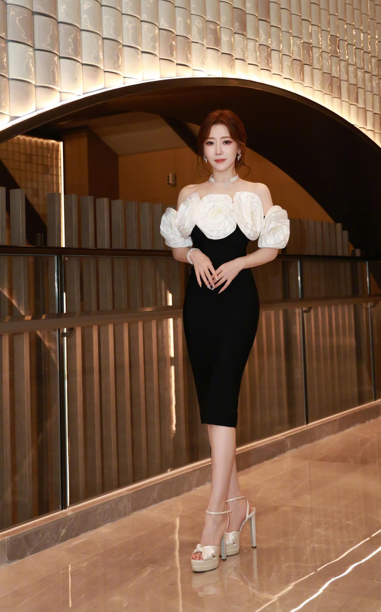 黑白撞色的优雅名媛风礼服，贵气又吸睛！
 
露肩设计+立体花朵装饰，黑白配色经典