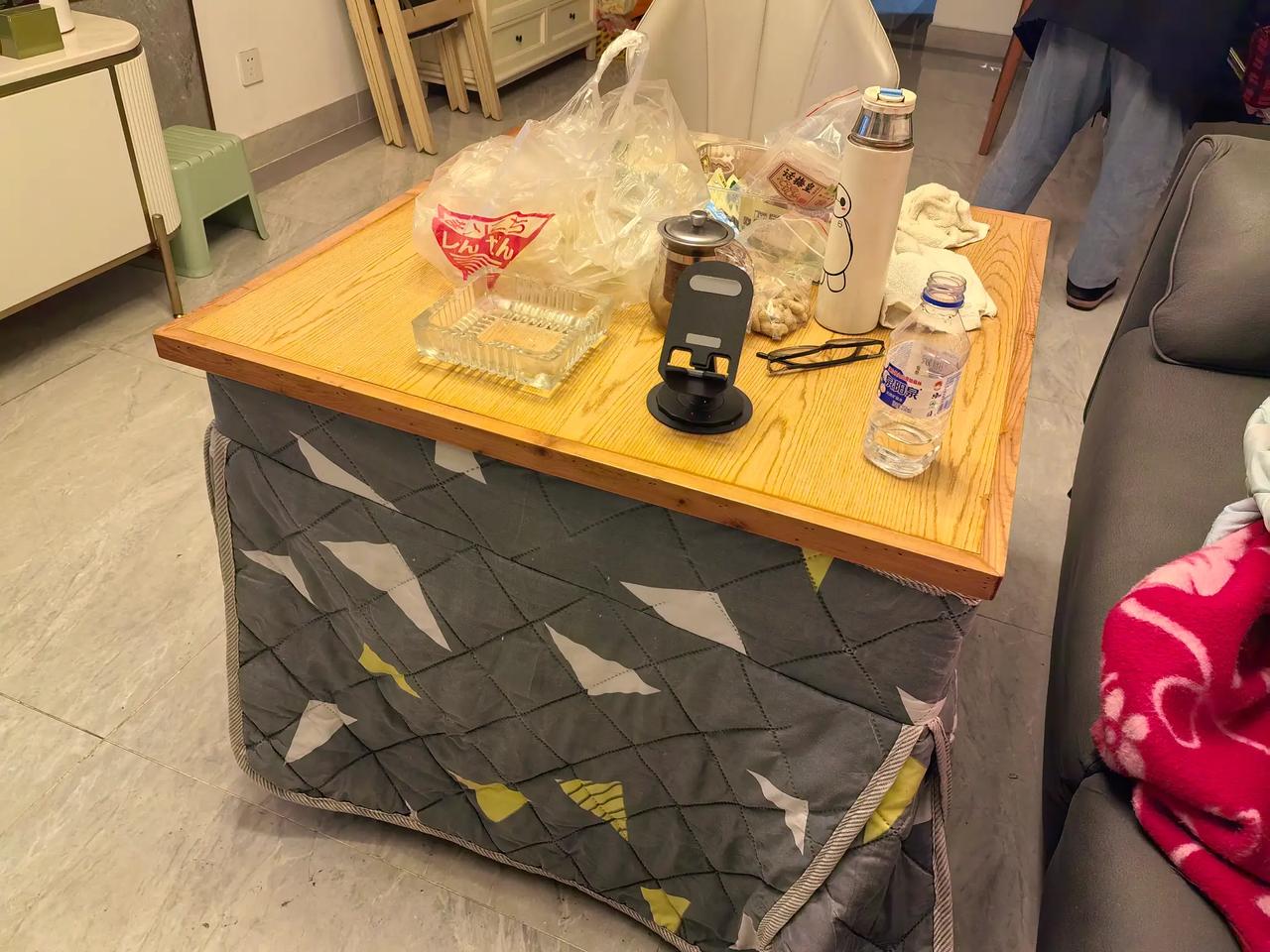 常德的烤火桌。桌下是电烤炉，桌面可以吃饭、做作业、烘衣服。方便，安全，脚放在被子