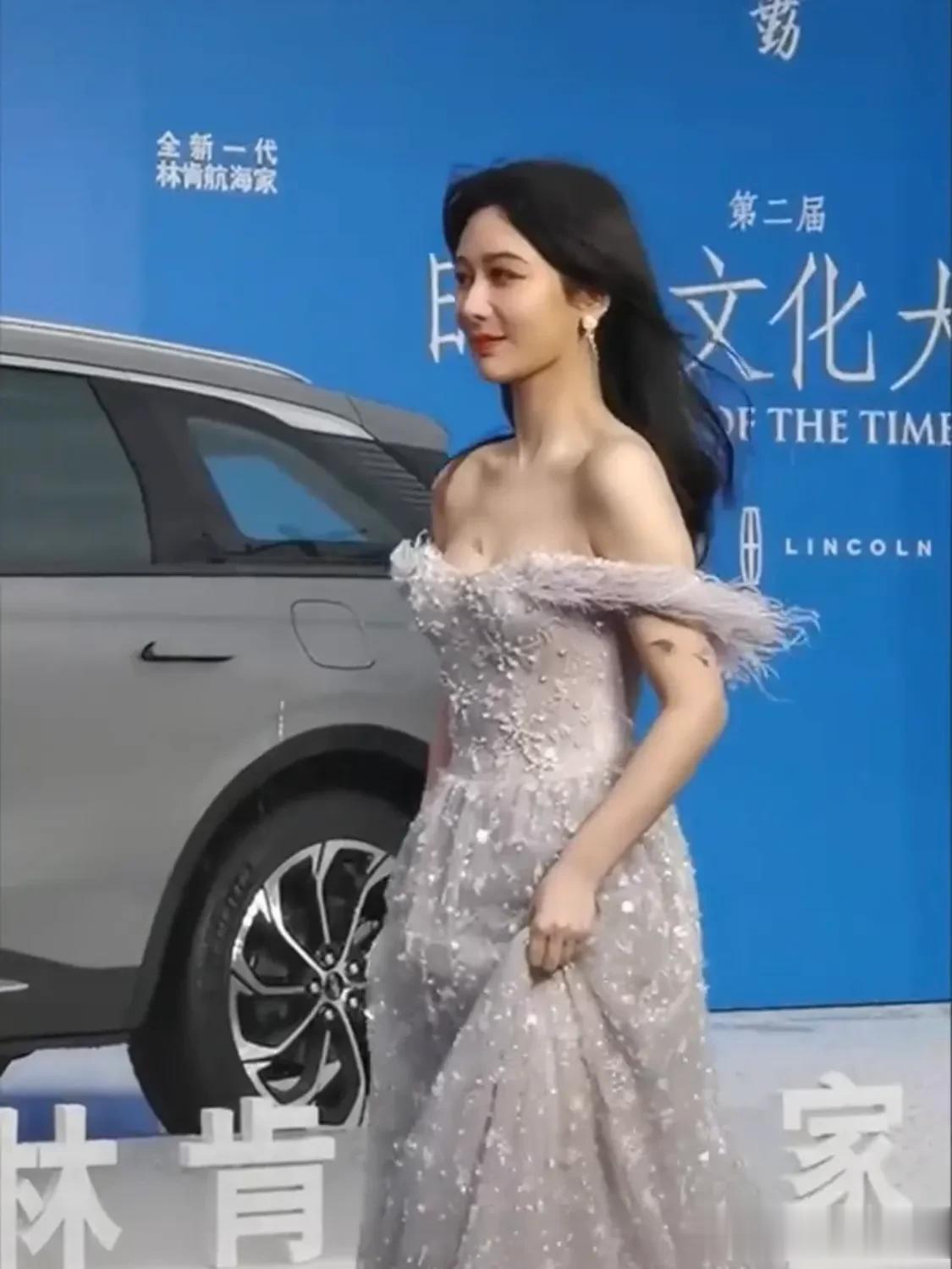 杨紫亮相时尚文化大赏蓝毯，轮到她走红毯的时候突然刮起大风下起雨来，被雨淋湿冻得瑟