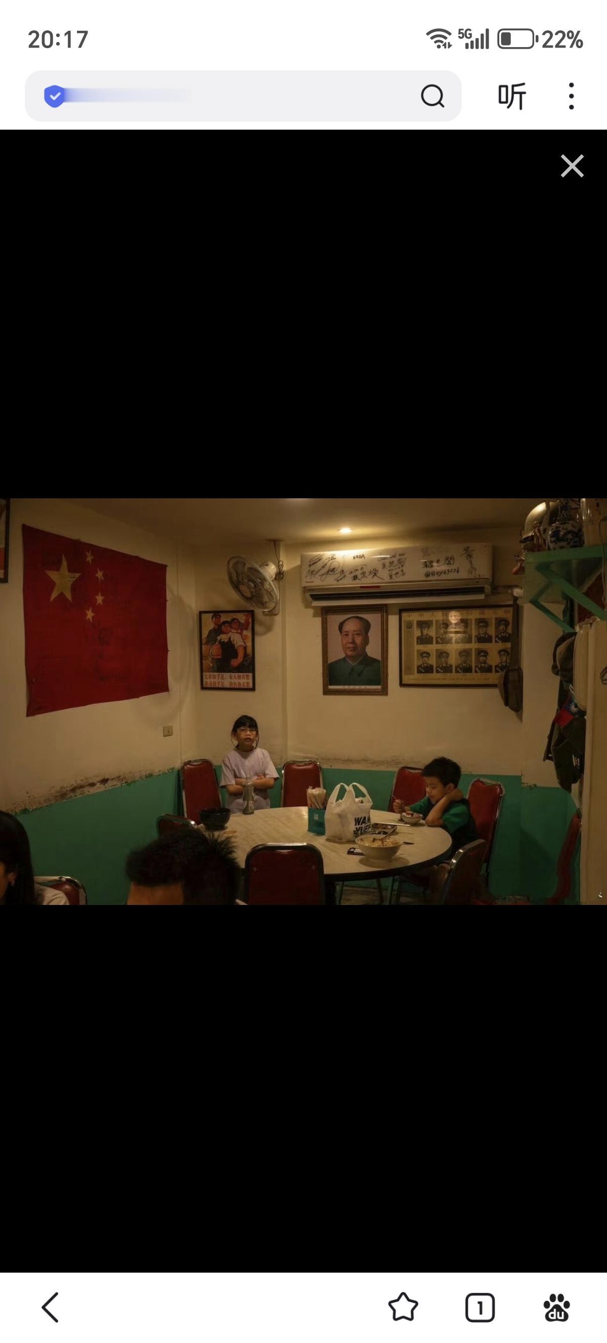 台湾桃园的一家餐厅，墙上挂着中国国旗与教员的头像，这里居住着1949年从大陆败退