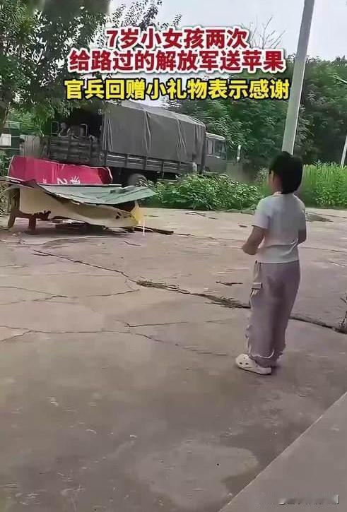 山东某地部队拉练途经村庄，7岁的小女孩攥着两个红苹果，追着队伍跑了几十米，两次塞