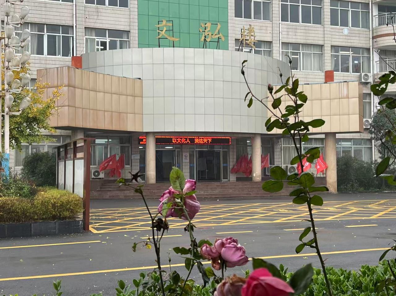 早起的校园，一片安静。
天空中飘着蒙蒙细雨，校园里湿湿的。
长廊的檐角挂着细密的