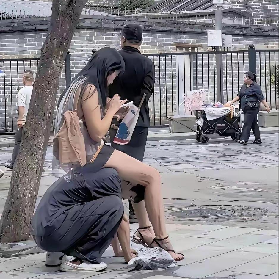 这一幕看了真让人五味杂陈！
 
路边拍到这张画面，男生蹲在地上，乖乖给女生系鞋带
