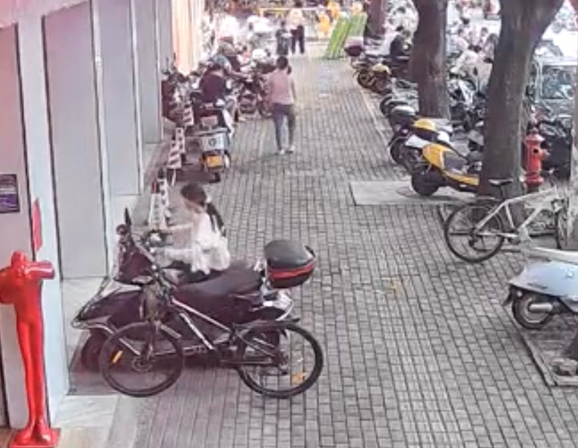 玉林一女子顺走两轮车上的一袋东西 玉林