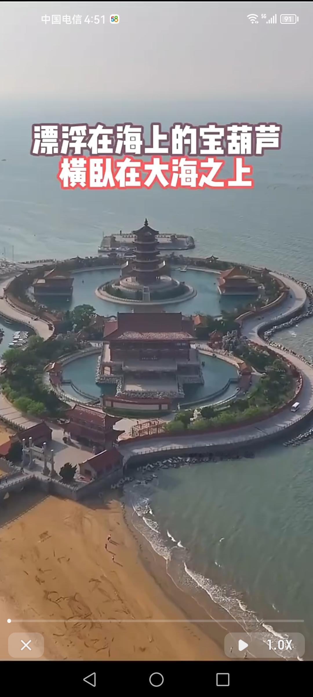 海上那个像宝葫芦的地方，就是山东蓬莱的八仙渡海口，传说是八仙过海的起点。
这儿环
