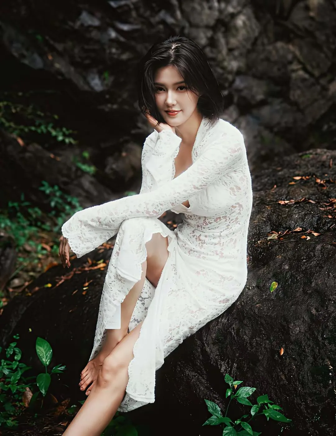 又看到迷人的她了。这次是白色蕾丝连体长裙穿搭户外写真。原始的山林背景...