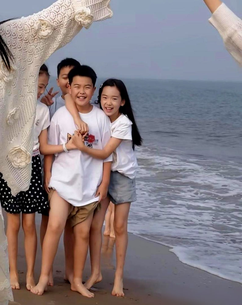 董璇佟丽娅在沙滩上手拉手，把自己弯成一道拱门。俩孩子排队从底下钻过去，笑得直打跌。
穿同款米色小熊外套，小酒窝搭着朵朵肩膀不撒手。旁边是高露，素着脸，孩子满屋跑。韩料店被偶遇那回，佟丽娅正夹一筷子泡菜饼往董璇碗里送。
阿那亚那套小别墅，董璇常带女儿去住。这次多了个能一起遛娃的人。沙滩追浪、玩沙、