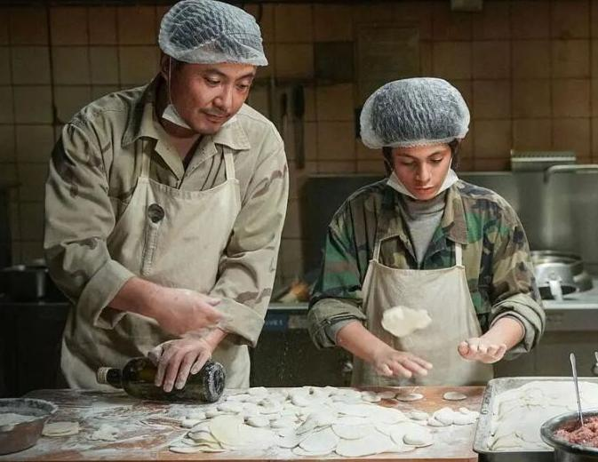 沈腾演了这么多年喜剧，这回在《欢迎来龙餐馆》里，最戳人的，反而是他收起笑的那一刻。
故事不复杂：一个叫徐福的东北厨子，欠着债，跑到中东支了家小餐馆，跟经理两个人硬把日子往前扛。后来炮火烧过来，那家原本做饭的铺子，慢慢成了几个孩子躲身的角落。
沈腾这次明显把喜剧腔收了起来。前半段他还是那副市井做派，插