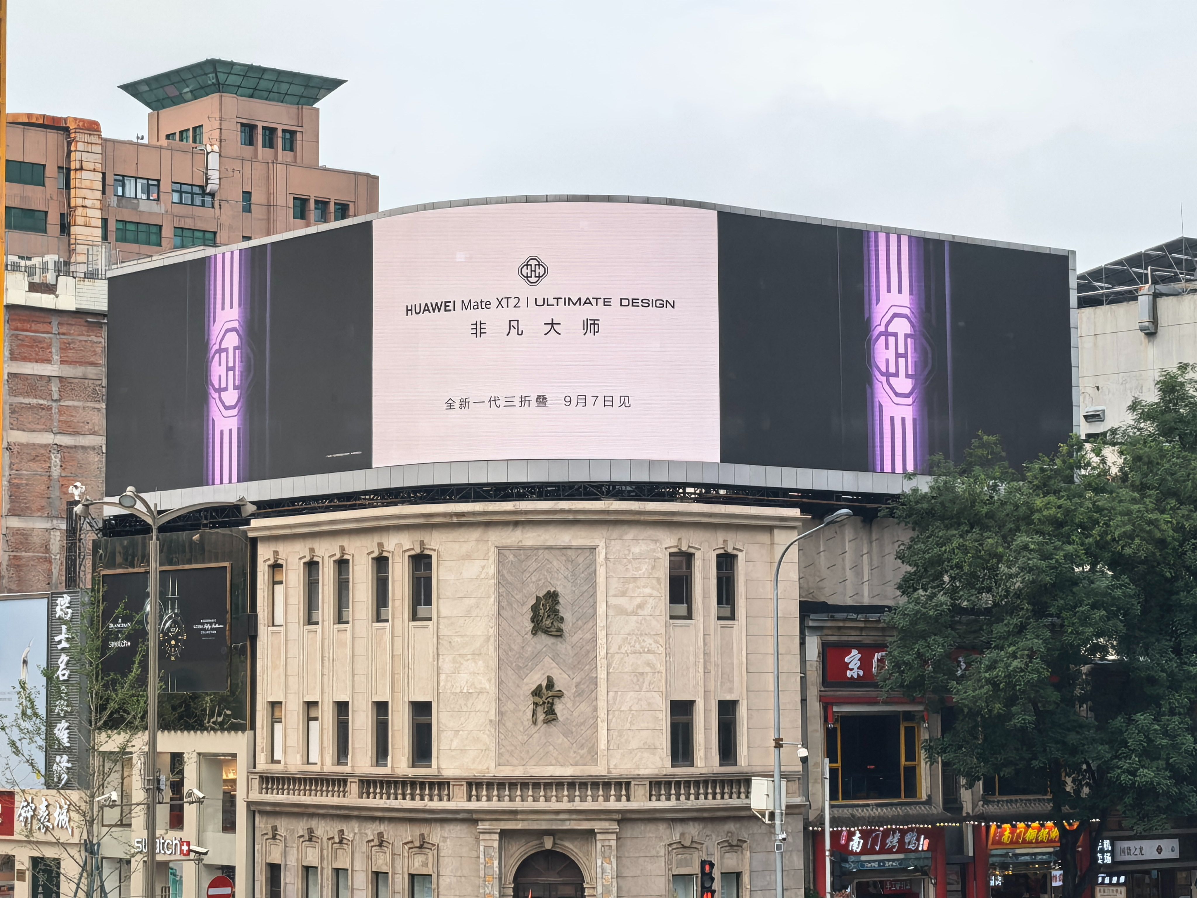 嚯！核心商圈大屏开始上HUAWEI Mate XT 2的局部设计细节了呀，有点迫不及待的掏出来给大家看看了！不得不说细节上确实有东西的。

镜头模组饰圈是紫色宝石切面的质感，机身用了很深邃的暗紫色打底，背板纹理顺着机身结构自然铺展，多层编织的肌理看着就很细腻，还带点东方美学的味道。转轴部分做工看着 ​