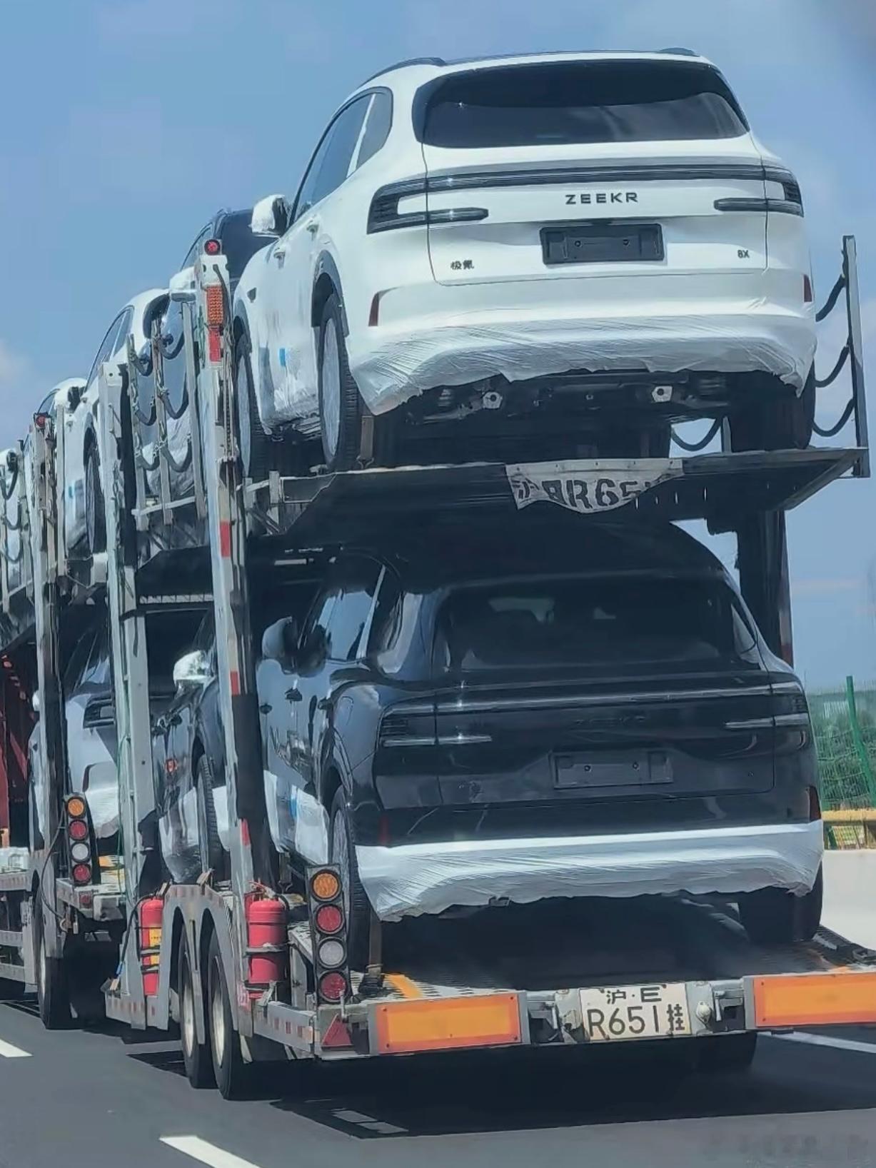 下班偶遇汽车发运，这又是极氪哪款车？
下班路上旁边直接停了台大板车，车上整整上十台呢，清一色全是8X曜夜套装。
车上还包着原厂运输保护膜呢，一看就是刚从工厂发出来的新车。
竖条样式的前脸格栅辨识度很高，和普通版的造型差别很明显。
就连路过骑电动车的大哥都忍不住扭头多看几眼。
#极氪8X# ​