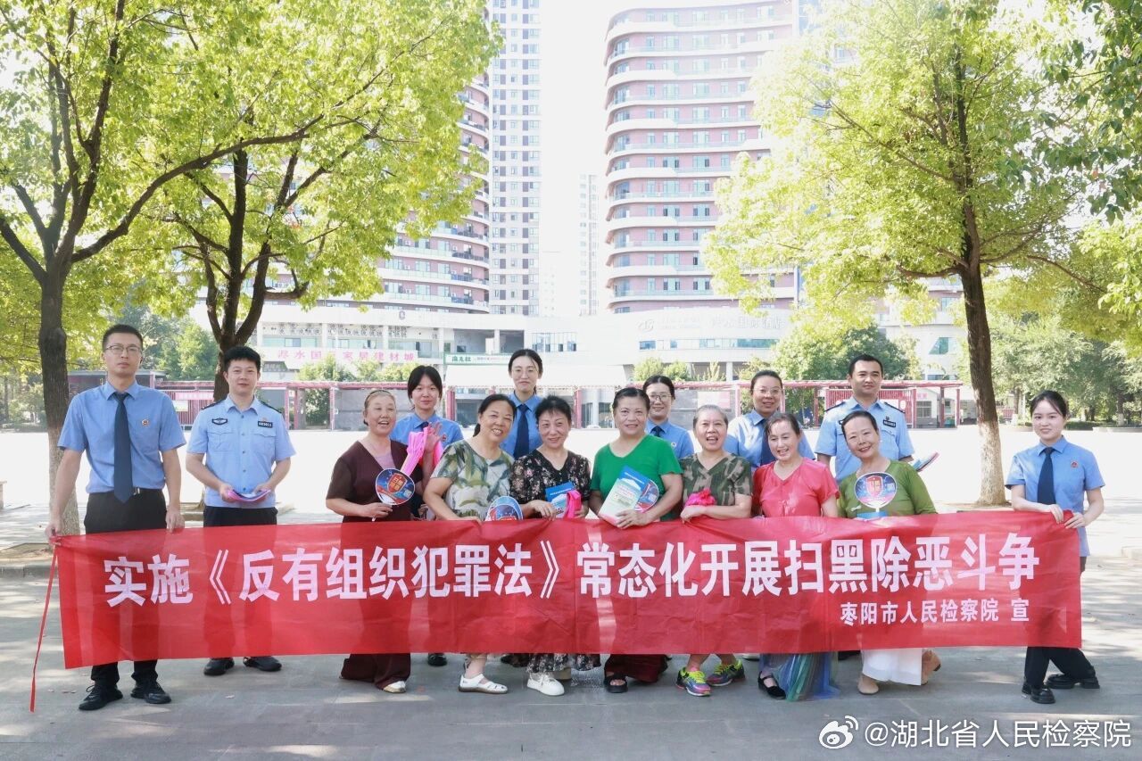 #鄂检新闻#【扇子一摇，黑恶无处逃】枣阳市人民检察院联合市公安局走上街头，开展《反有组织犯罪法》主题宣传。干警们挂横幅、发手册，用真实案例唠嗑式讲解强买强卖、欺行霸市、敲诈勒索等有组织犯罪套路，还专门定制了印有扫黑除恶标语和12337举报平台二维码的“平安扇”，既给群众送清凉又手把手教 ​