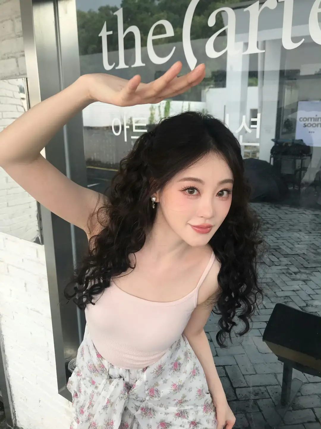 她摆了个姿势，站在店门口。 (祝绪丹)