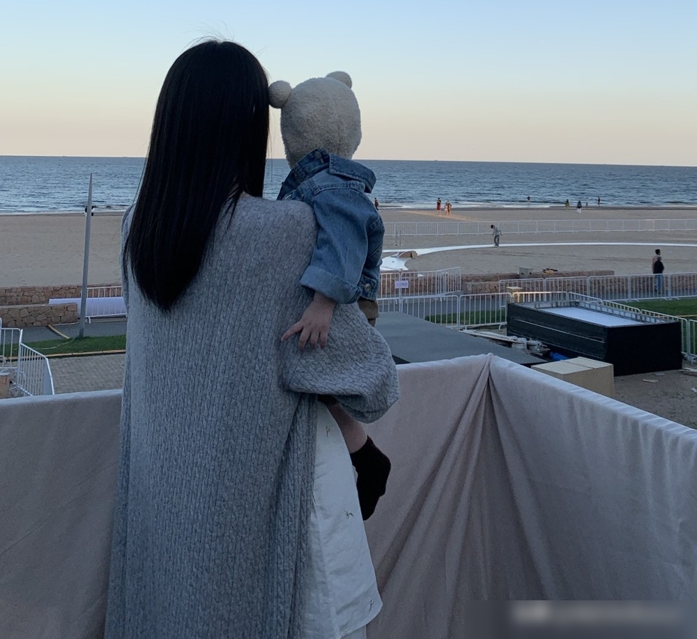 何穗37岁生日，晒的不是豪宅不是包包，是一个用旧布料缝出来的周岁礼服。
她穿着黄色吊带，在家对着插蜡烛的面包蛋糕许愿。儿子小Win全程背影、后脑勺、小手小脚出镜，正脸一张没露。
蛋糕道具是她亲手做的，周岁场景是她搭的，连那件礼服，都是她和她妈拿旧布剪裁缝出来的。
小Win遗传了她的冷白皮，手长