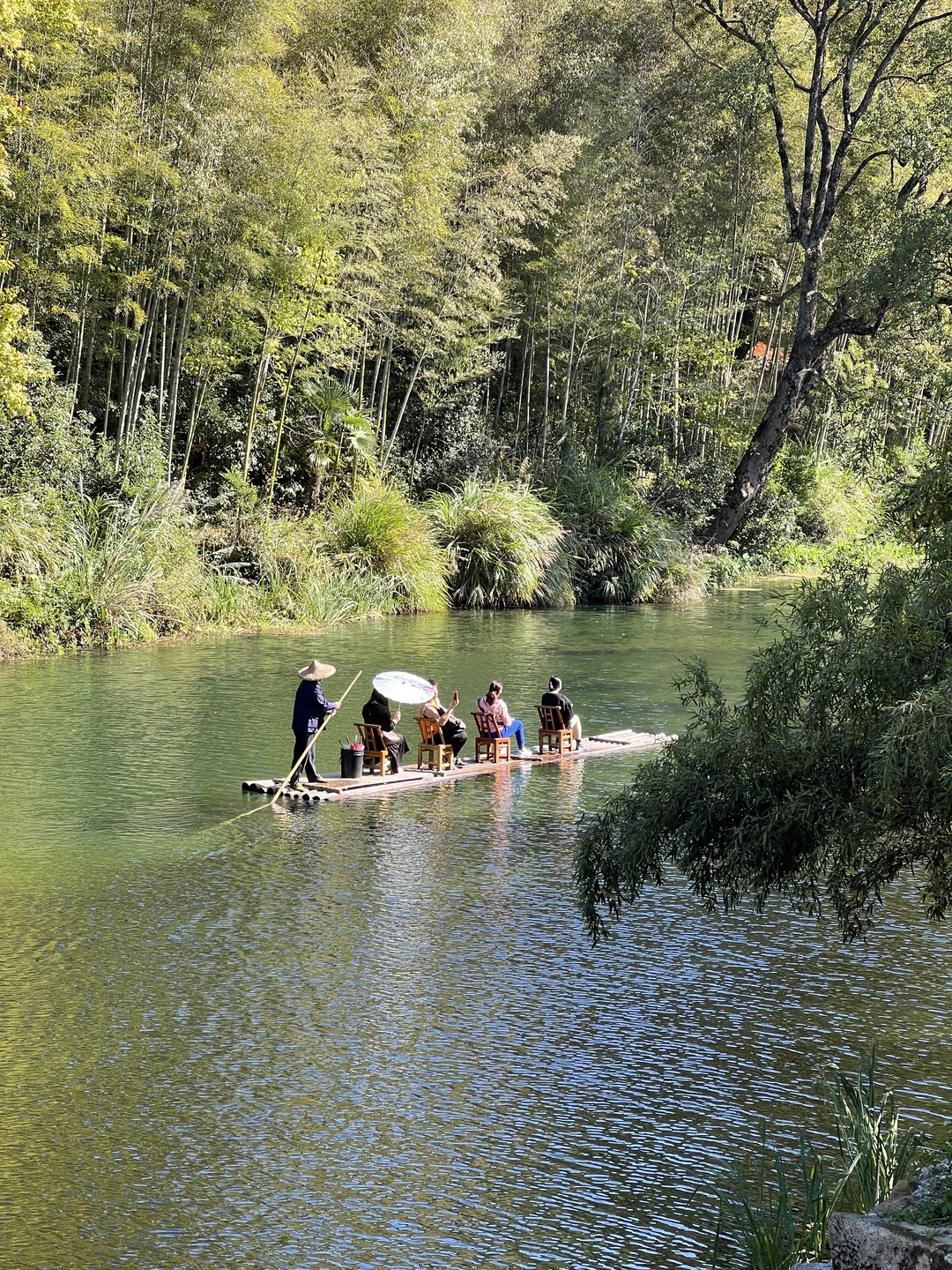 人闲竹排上，影倒碧波中，看山峦如卷轴在身旁