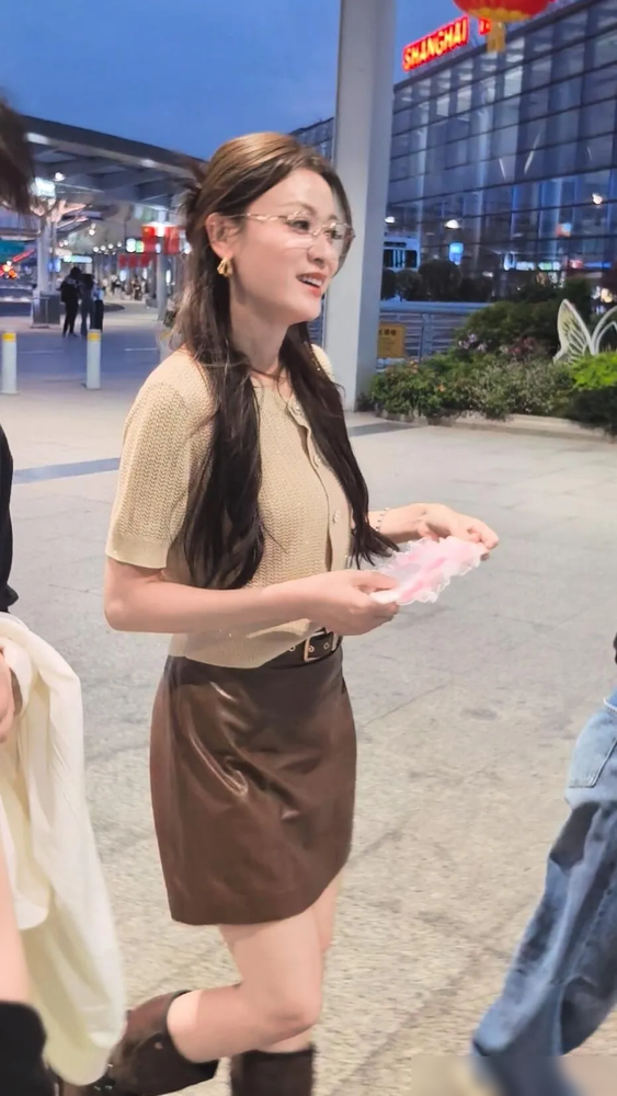 活到40岁，叶一茜突然把少妇感穿明白了。
浅金色细闪针织短袖，下身咖色皮短裙，脚上蹬一双同色系长筒靴。半扎头发，细框眼镜一戴，金色耳饰晃得人挪不开眼。
没有露腰，没有oversize，没有硬凹少女。就是一身柔和的大地色，从上到下顺下来，利索、知性，还带点早秋的清爽劲儿。
以前总觉得她是田亮背后