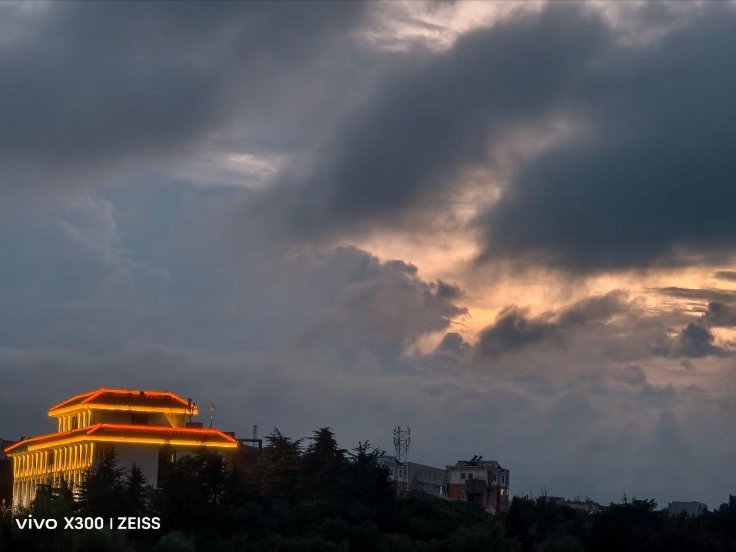 #vivo[超话]##vivo超话# 天上乌云起，挡不住夕阳的光芒，楼下那个房子也发出橙色的光芒。 ​