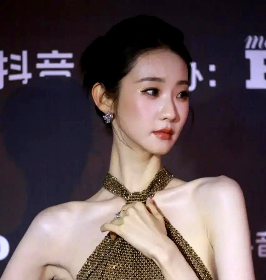 连换三套高难度礼服，这哪是走红毯，简直是拿骨相在“杀人”。

费加罗之夜那件金色真空挂脖亮片裙，换个没底子的人穿准勒出斜方肌。张艺凡硬是靠十几年芭蕾熬出的天鹅颈，把这块布撑住了。

转头换上白纱和水蓝外袍，镜头直接怼到脚踝，连足弓的弧度都绷得像尺子量过。没有含胸拔背，全靠肌肉记忆生扛高清镜头。

这