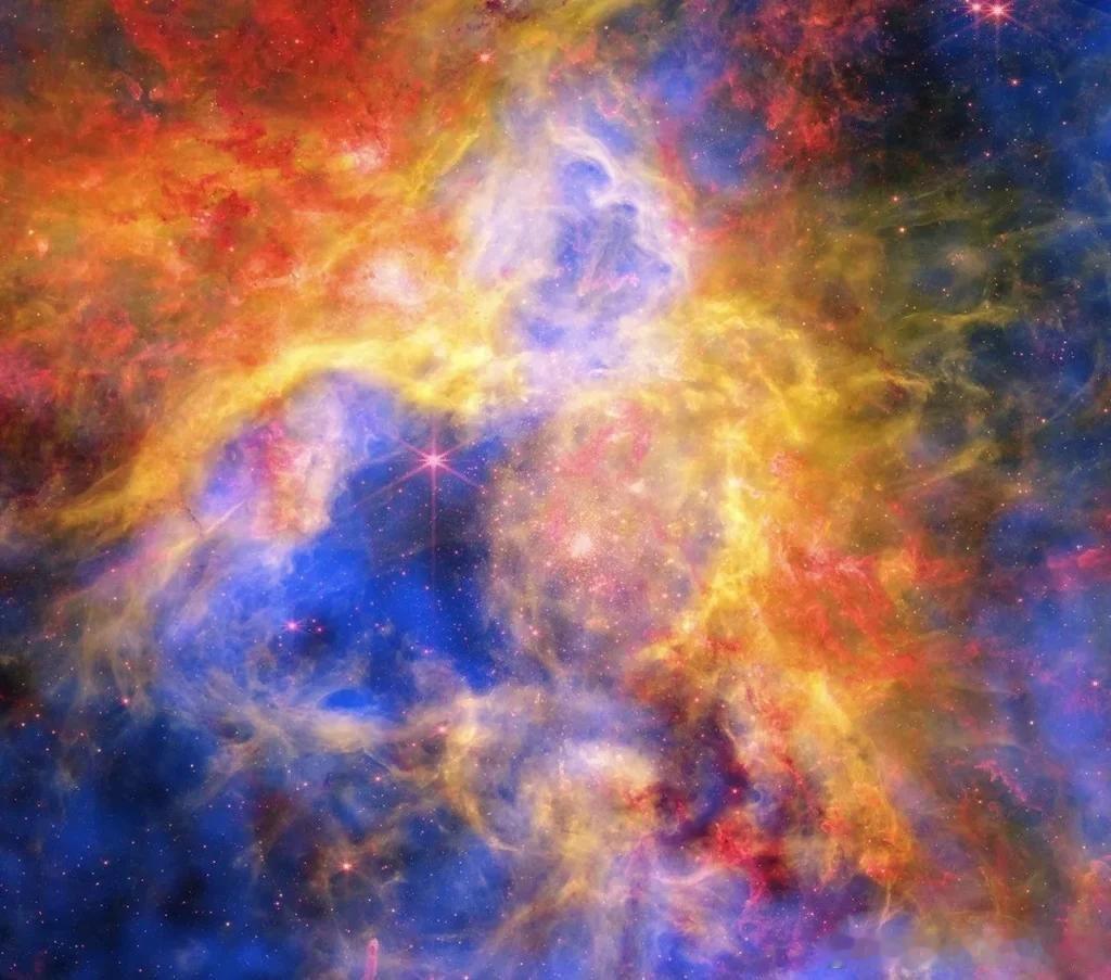 在这张2026年8月11日的图像中，来自NASA的钱德拉X射线天文台、NASA的詹姆斯·韦伯太空望远镜和NASA的哈勃太空望远镜的数据相结合，展现了剑鱼座30（或称狼蛛星云）充满活力的景象。位于大麦哲伦星系（银河系的一个小型邻近星系，距离地球约160,000光年）中的狼蛛星云拥有数千颗年轻恒星，它们镶嵌在由气 ​